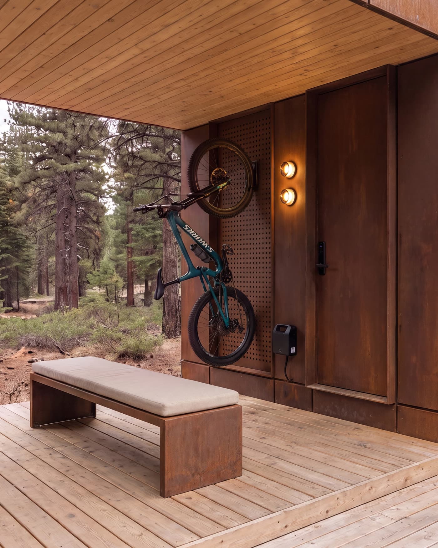 A covered deck with a bench and a mountain bike hung on the wall beside the door